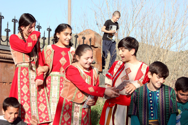 Kids at the playgroud, some in traidtional dress