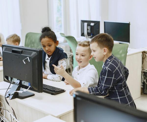 Young children looking at a computer screen