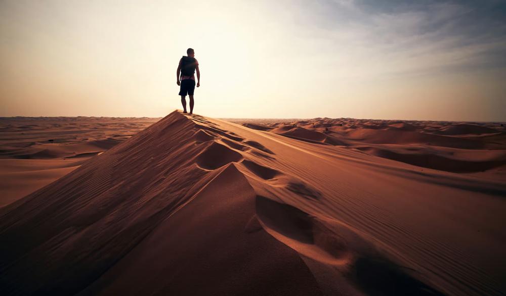 Man walking along a dune