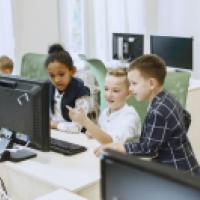 Young children looking at a computer screen